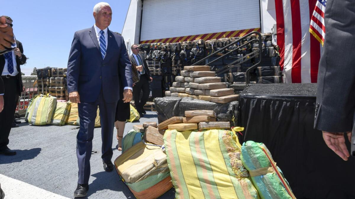 Vice President Mike Pence walks past bales of seized cocaine during a visit to the U.S. Coast Guard Cutter Munro on Thursday in Coronado, Calif.