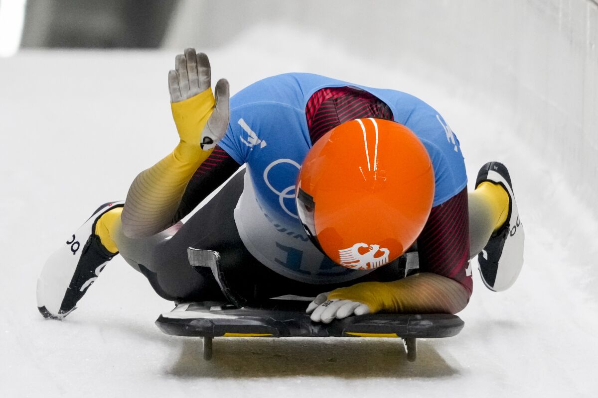 Hannah Neise, of Germany, celebrates winning the gold medal in the women's skeleton at the 2022 Winter Olympics, Saturday, Feb. 12, 2022, in the Yanqing district of Beijing. (AP Photo/Dmitri Lovetsky)
