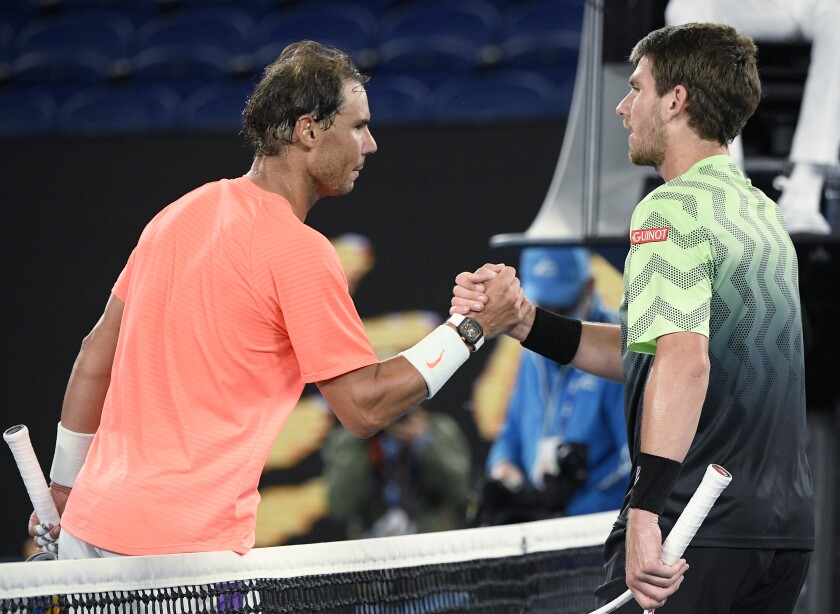 Spain's Rafael Nadal, left, shakes hands with Britain's Cameron Norrie after winning their third round match a the Australian Open tennis championships in Melbourne, Australia, Saturday, Feb. 13, 2021. (AP Photo/Andy Brownbill)