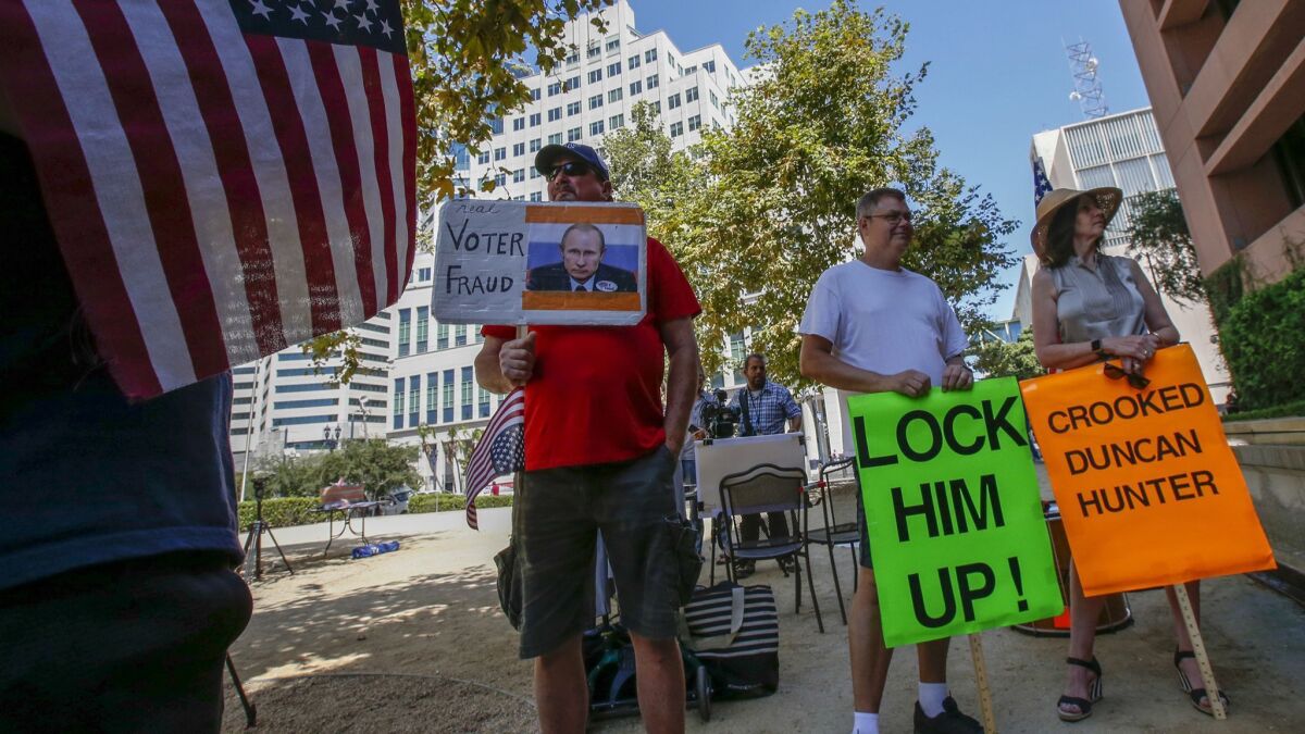 Protesters demonstrate outside the San Diego courthouse where Rep. Duncan Hunter was arraigned.
