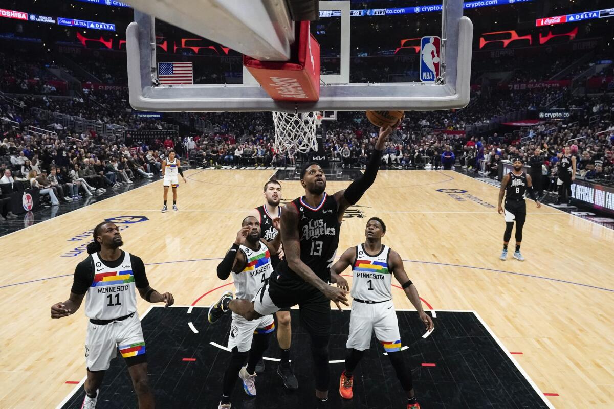 Clippers guard Paul George shoots during the second half against the Minnesota Timberwolves.