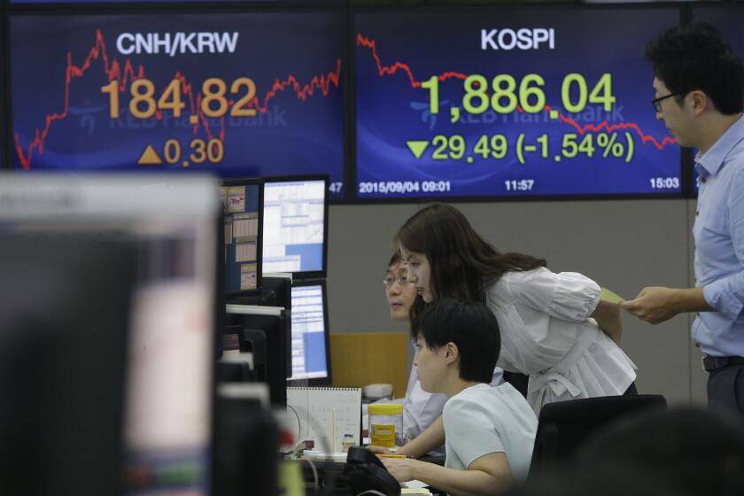 Currency traders watch monitors at the foreign exchange dealing room of KEB Hana Bank headquarters in Seoul, South Korea.