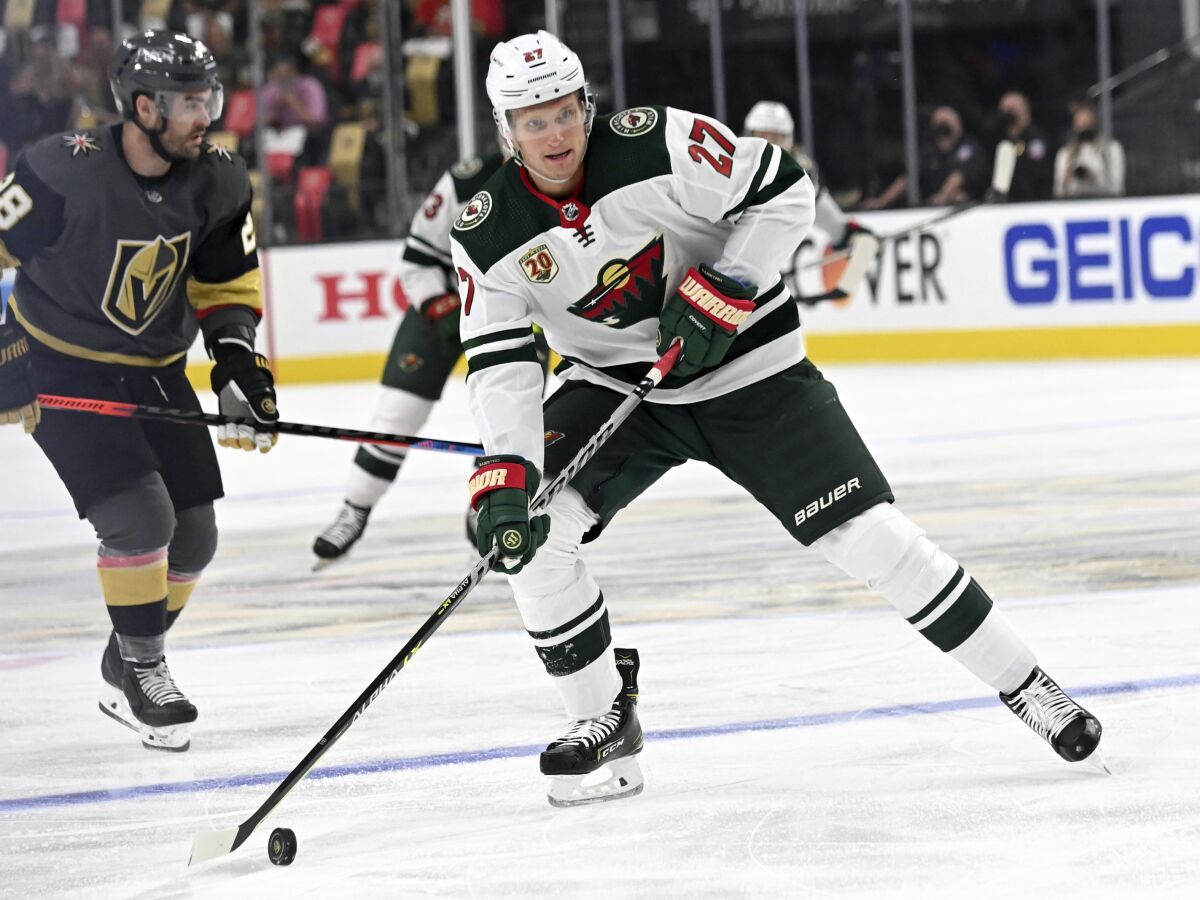 FILE - In this May 18, 2021, file photo, Minnesota Wild's Nick Bjugstad (27) skates with the puck against the Vegas Golden Knights during the first period of Game 2 of a first-round NHL hockey playoff series in Las Vegas. The Wild have re-signed Bjugstad to a one-year, $900,000 contract. The move brings back some useful depth up front. (AP Photo/David Becker, File)