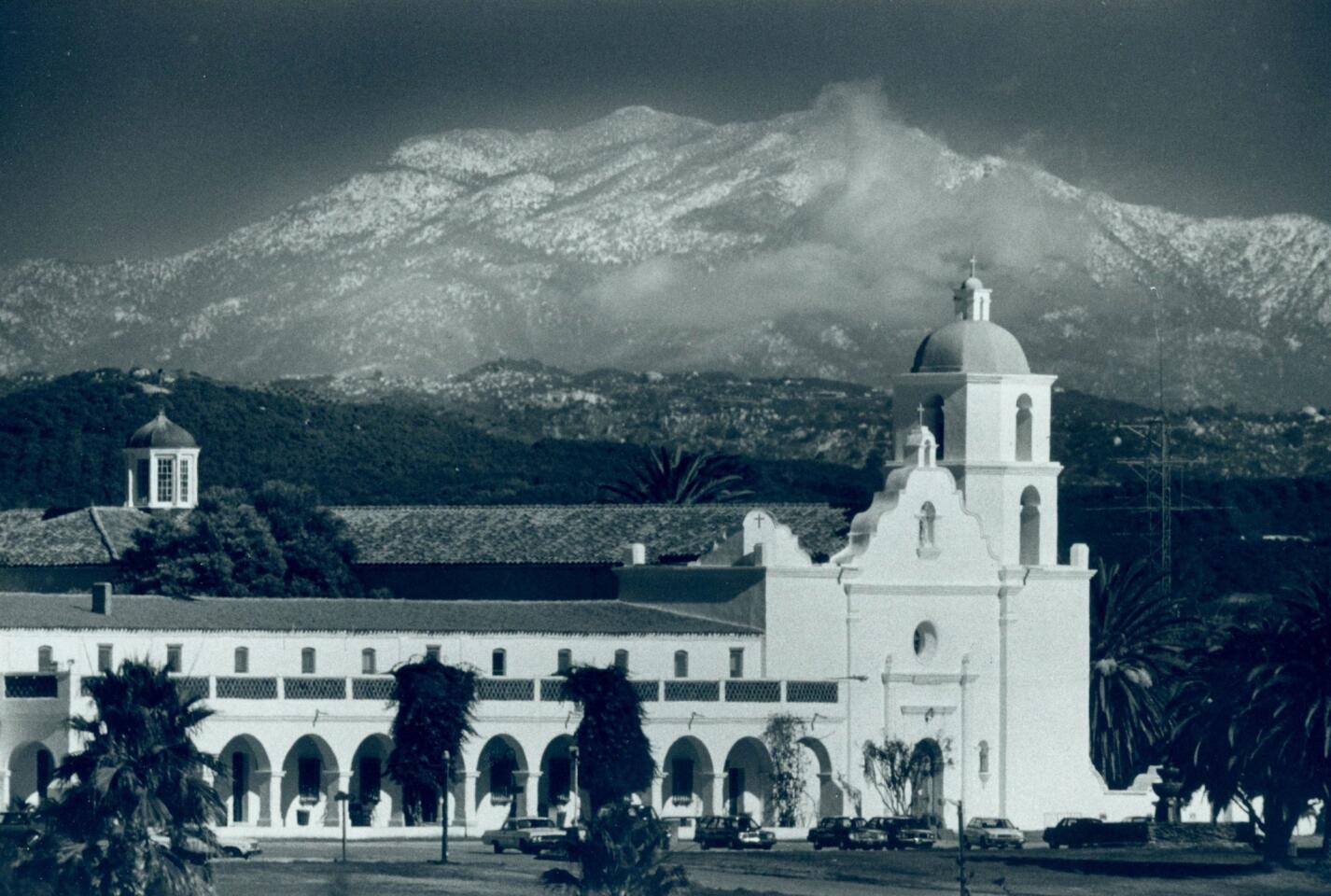 Distant snow-covered peaks rise behind San Luis Rey mission east of Oceanside, Calif. The mission is named for Louis IX, the only canonized king of France