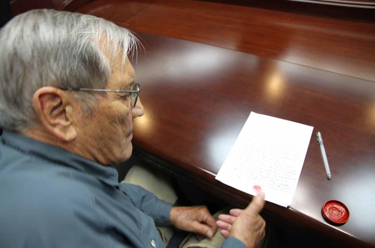 This photograph released by North Korea's official Korean Central News Agencyshows U.S. citizen Merrill Newman inking his thumbprint onto a written apology for his alleged crimes both as a tourist and during his participation in the Korean War, while under detention in Pyongyang.