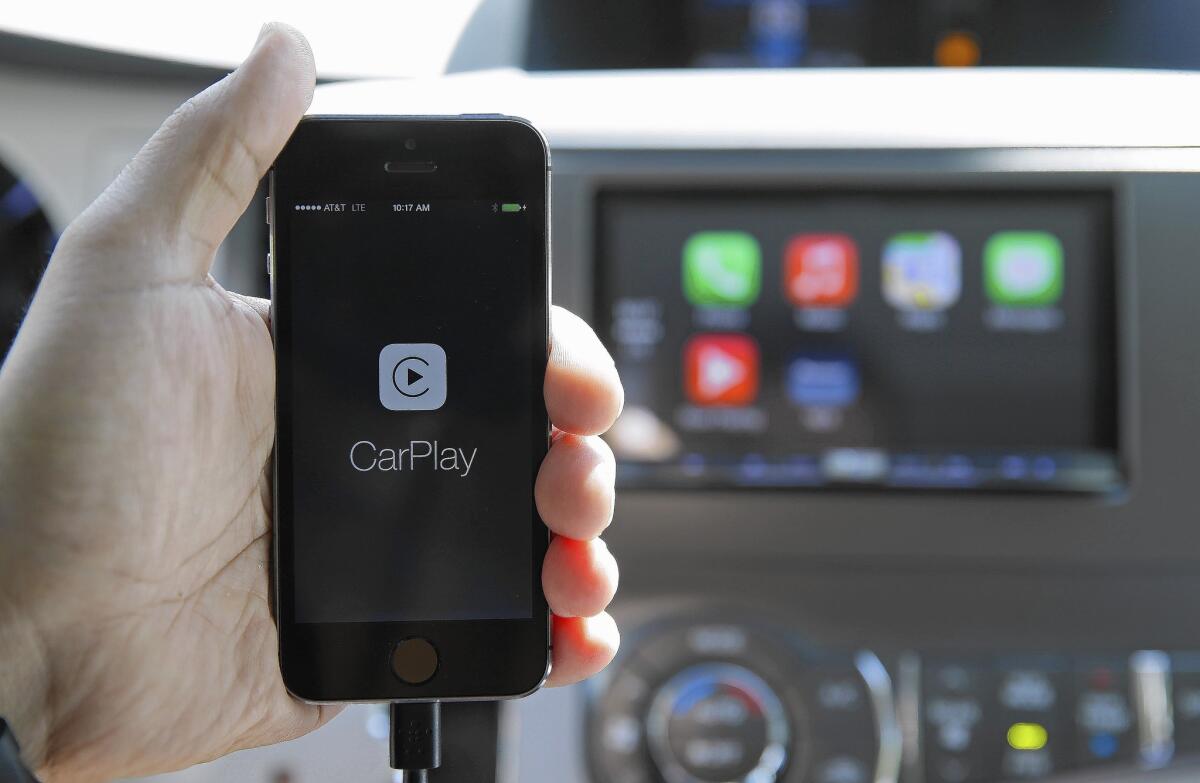 A Pioneer Electronics executive demonstrates an Apple CarPlay-compatible radio, which are controlled by voice or touch. The radios cost $700 to $1,400.