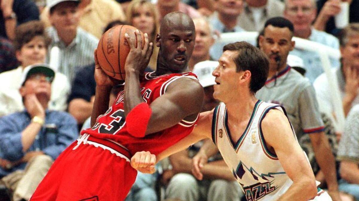 The Bulls' Michael Jordan posts up against Jeff Hornacek of the Jazz during the 1998 NBA Finals.