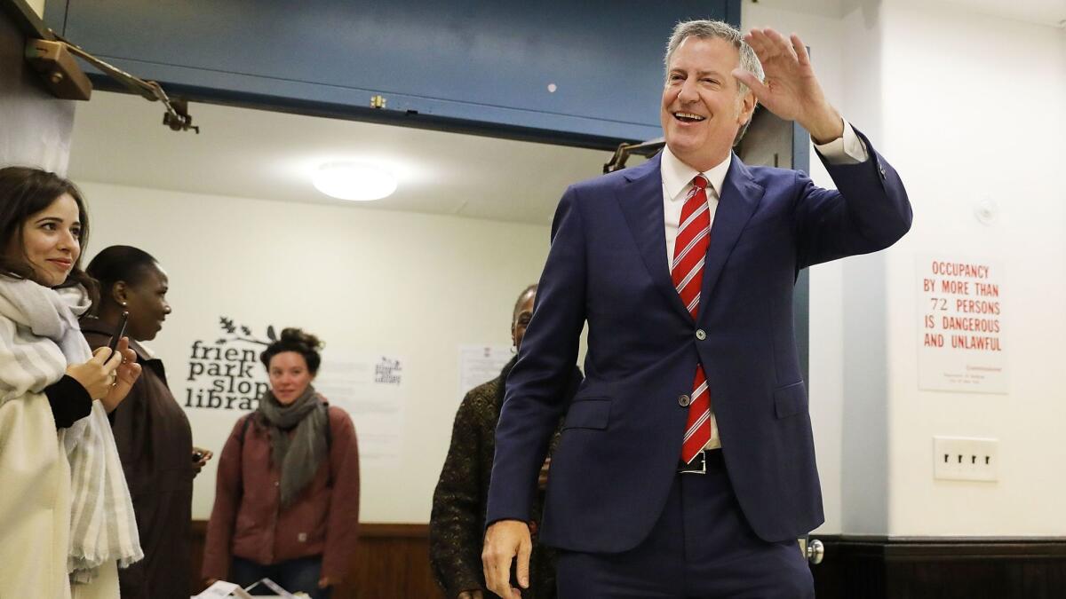 New York Mayor Bill de Blasio walks into his polling station in Brooklyn on Tuesday.