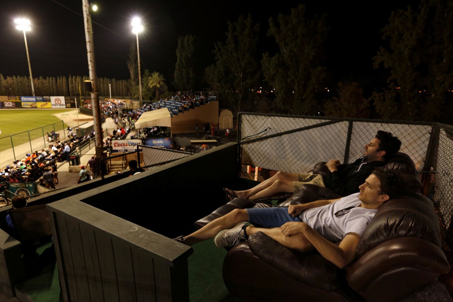 Eric Noble, foreground, and Eli Bauman rest comfortably in lounge chairs while watching one of the last games that the Bakersfield Blaze played at Sam Lynn Ballpark.