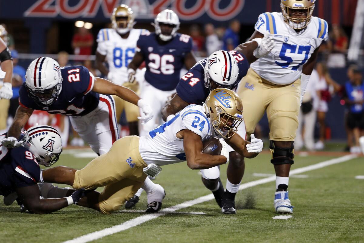 Zach Charbonnet gains yards against Arizona.