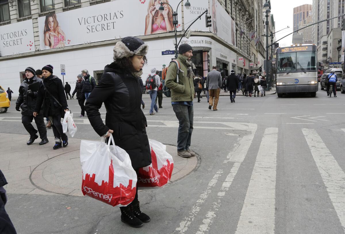 A shopper carries J.C. Penney shopping bags in New York on Feb. 19.