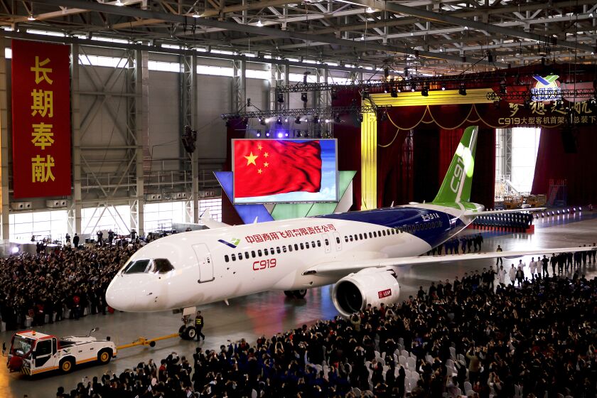 FILE - In this Monday, Nov. 2, 2015 file photo, the first twin-engine 158-seater C919 passenger plane made by The Commercial Aircraft Corp. of China (COMAC) is pulled out of the company's hangar during a ceremony near the Pudong International Airport in Shanghai, China. China Eastern Airlines Ltd. on Friday, Dec. 9, 2022, became the first customer to take delivery of the long-range jetliner produced by a state-owned manufacturer set up to try to compete with Boeing and Airbus, state TV reported. (AP Photo, File)