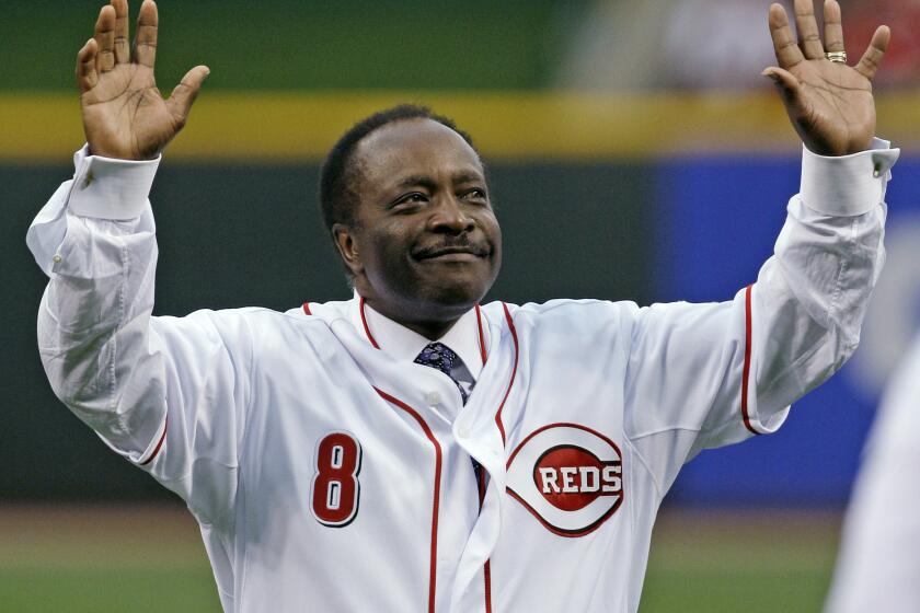 FILE - In this Wednesday, April 7, 2010, file photo, Cincinnati Reds Hall of Fame second baseman Joe Morgan acknowledges the crowd after throwing out a ceremonial first pitch prior to the Reds' baseball game against the St. Louis Cardinals, in Cincinnati. Hall of Fame second baseman Joe Morgan has died. A family spokesman says he died at his home Sunday, Oct. 11, 2020, in Danville, California. (AP Photo/Al Behrman)