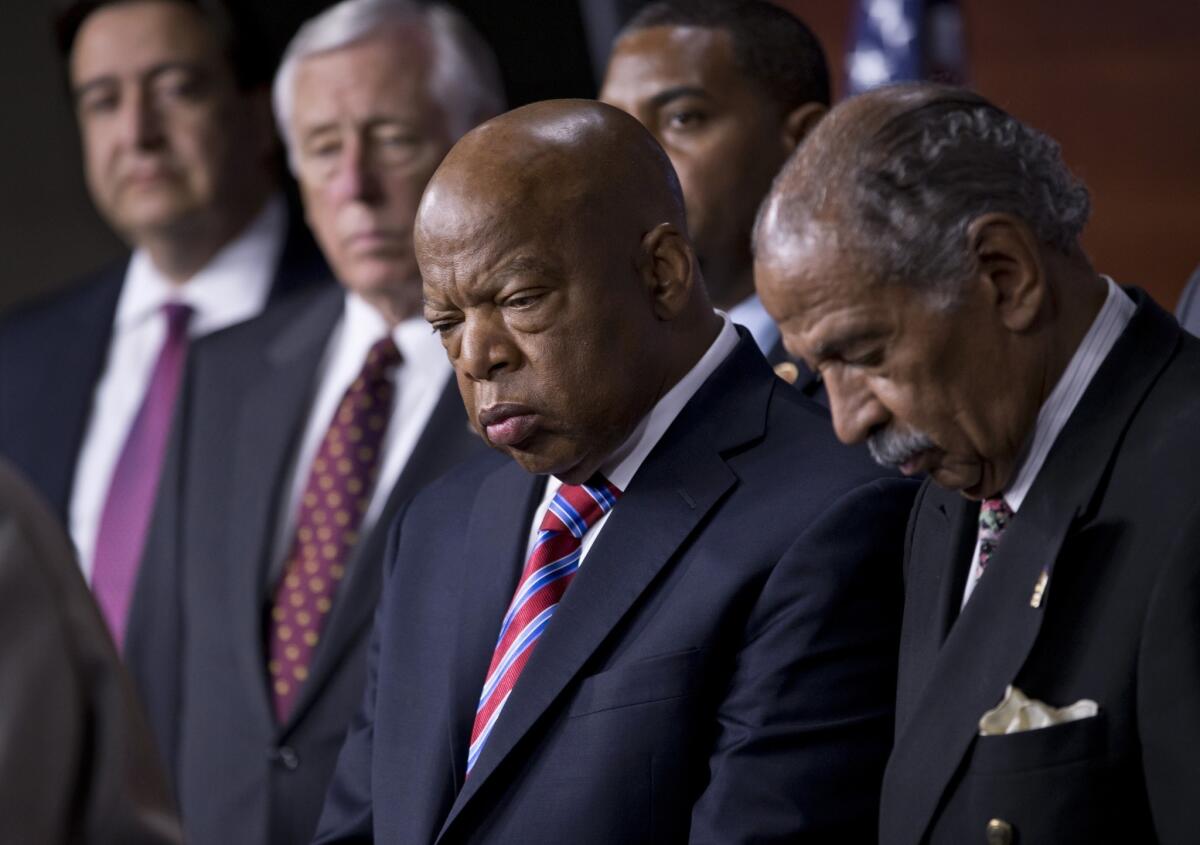 In ruling unconstitutional a key part of the 1965 Voting Rights Act, the U.S. Supreme Court has opened the door for state and local governments with a history of discriminating against minorities to engage in subtle forms of disenfranchisement. Above: Rep. John Lewis (D-Ga.), center, and Rep. John Conyers (D-Mich.), right, co-chairs of the Civil Rights Taskforce of the Congressional Black Caucus, join other members of the House to express disappointment in the Supreme Court's decision.