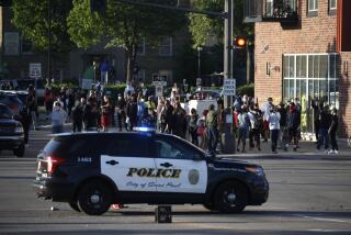 Protesters gather Thursday, May 28, 2020, in St. Paul, Minn. Minnesota Gov. Tim Walz called in the National Guard on Thursday as looting broke out in St. Paul and a wounded Minneapolis braced for more violence after rioting over the death of George Floyd, a handcuffed black man in police custody, reduced parts of one neighborhood to a smoking shambles. (AP Photo/John Minchillo)