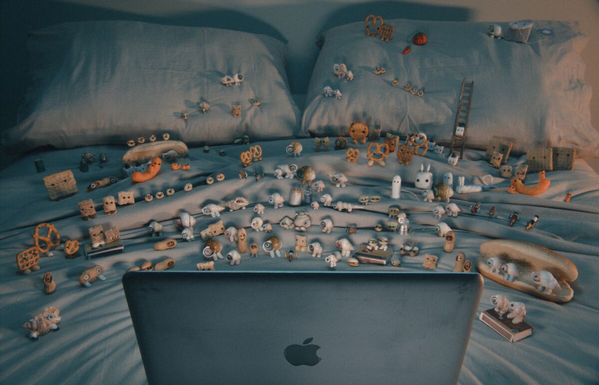 A large community of shells with eyes watch a program on a laptop in "Marcel the Shell with Shoes On."