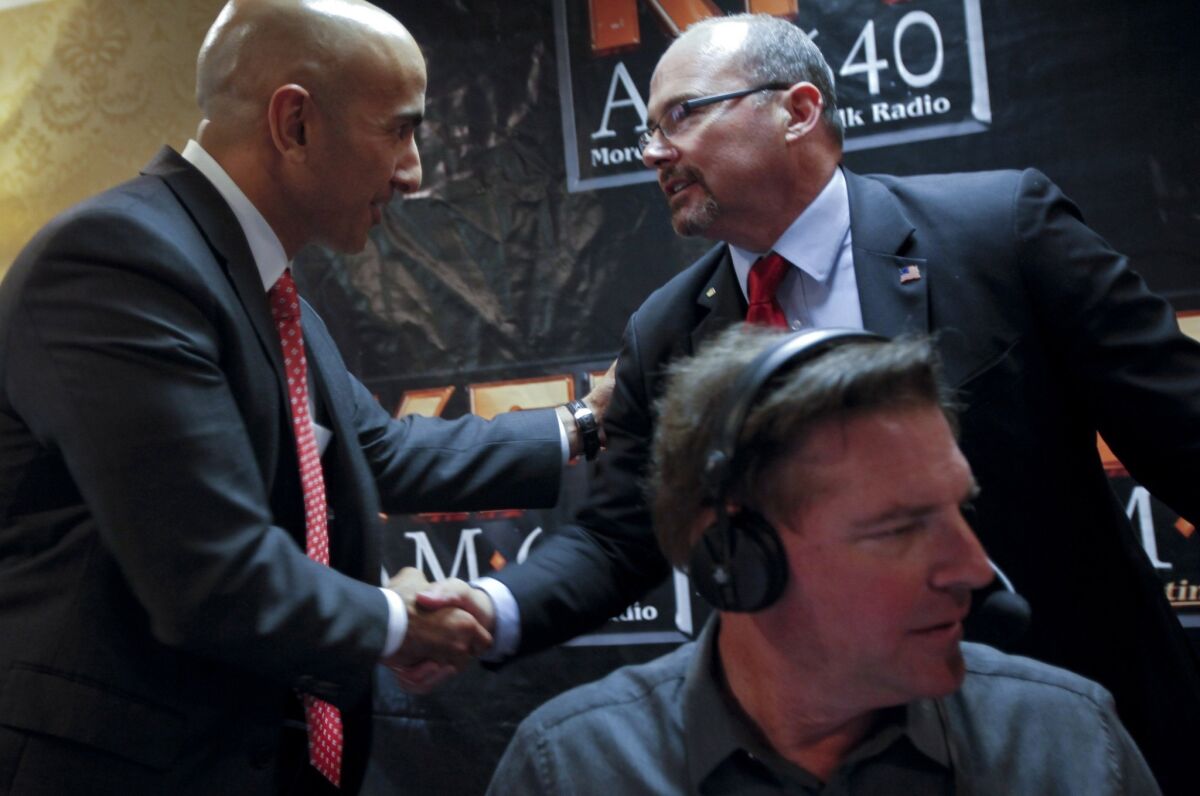 Republican candidates for governor Neel Kashkari, left, and Tim Donnelly after an appearance on the John and Ken show on KFI-AM in May.