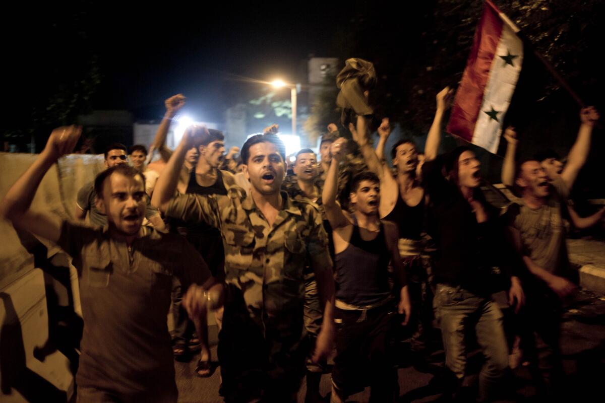 Syrian soldiers celebrate Bashar Assad's presidential reelection in Damascus.