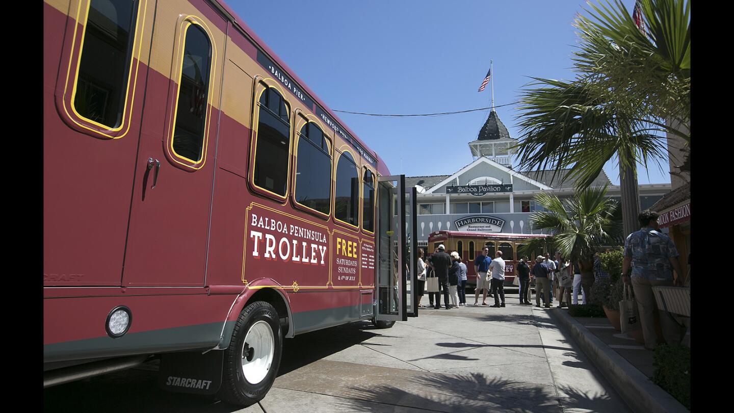 One of the new Peninsula trolleys stops at the Balboa Pavilion during a preview tour Friday in Newport Beach.