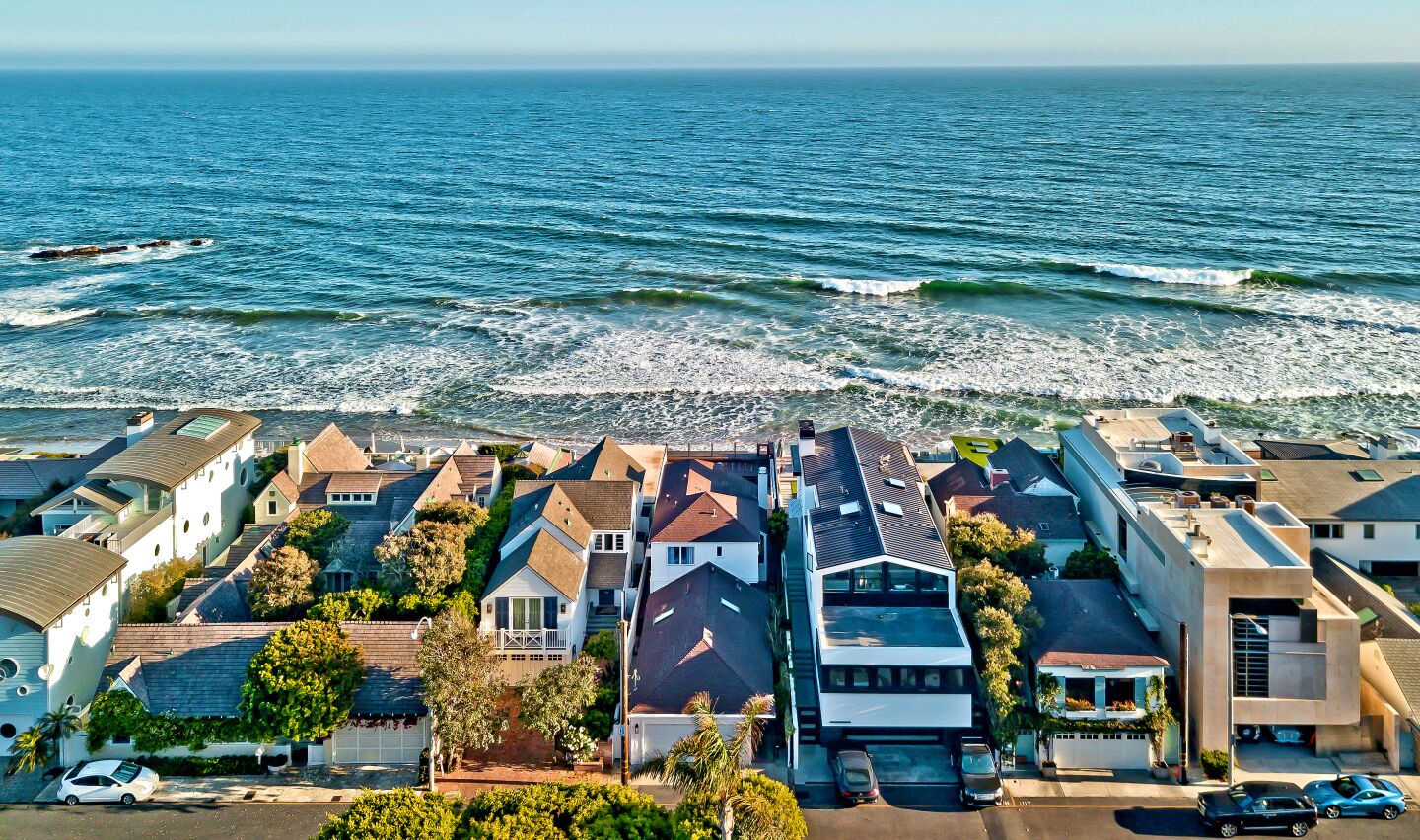 An aerial view of closely packed, ocean-facing mansions at Malibu Colony Beach.