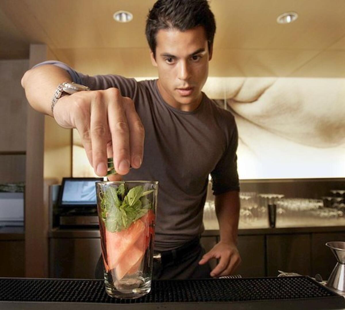 ICY: Paulo Fagundez muddles cucumber and watermelon.