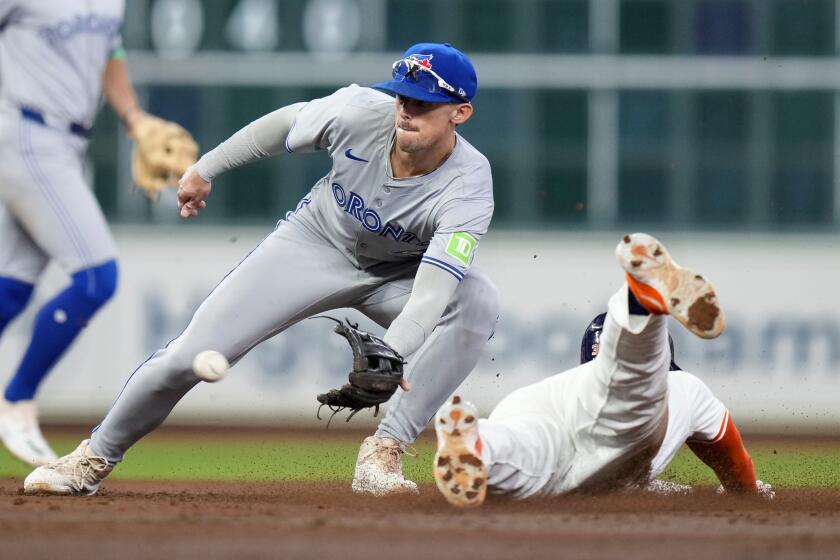 Houston Astros' Kyle Tucker, right, steals second as Toronto Blue Jays second baseman Cavan Biggio catches the throw during the third inning of a baseball game Wednesday, April 3, 2024, in Houston. (AP Photo/Eric Christian Smith)