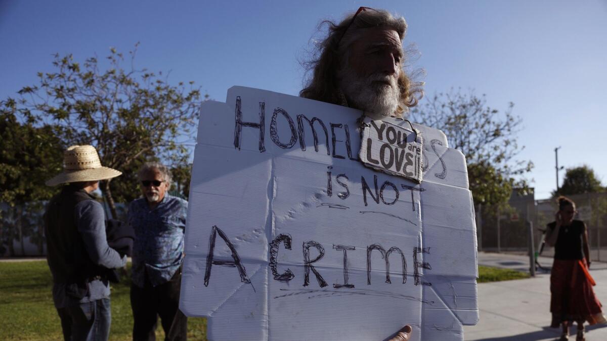 David Busch, 62, with the Coalition to End Homelessness, stands outside an open house at Westminster Elementary School last week in Venice.