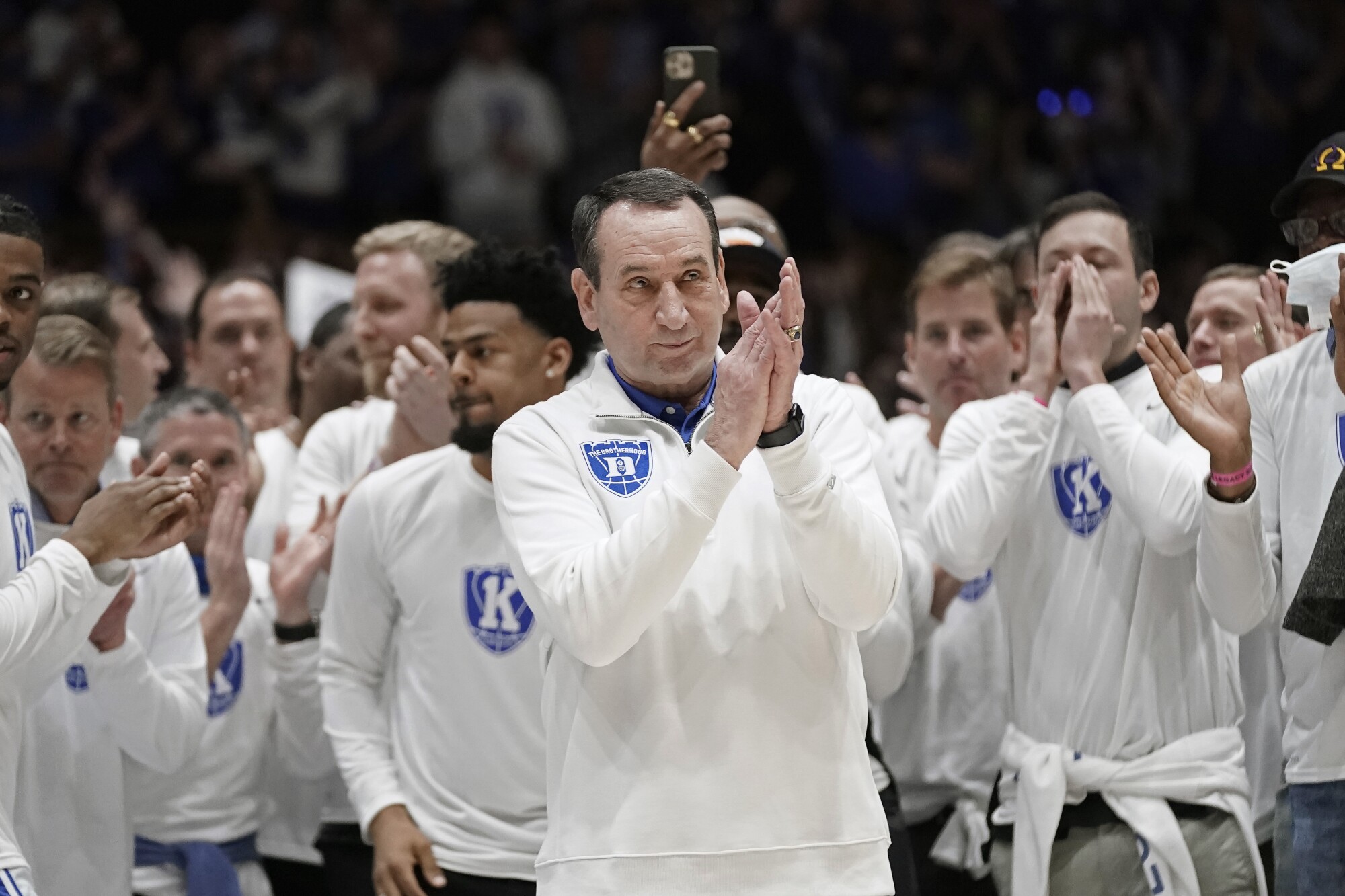 Duke coach Mike Krzyzewski applauds while being recognized before Sunday's game against North Carolina.