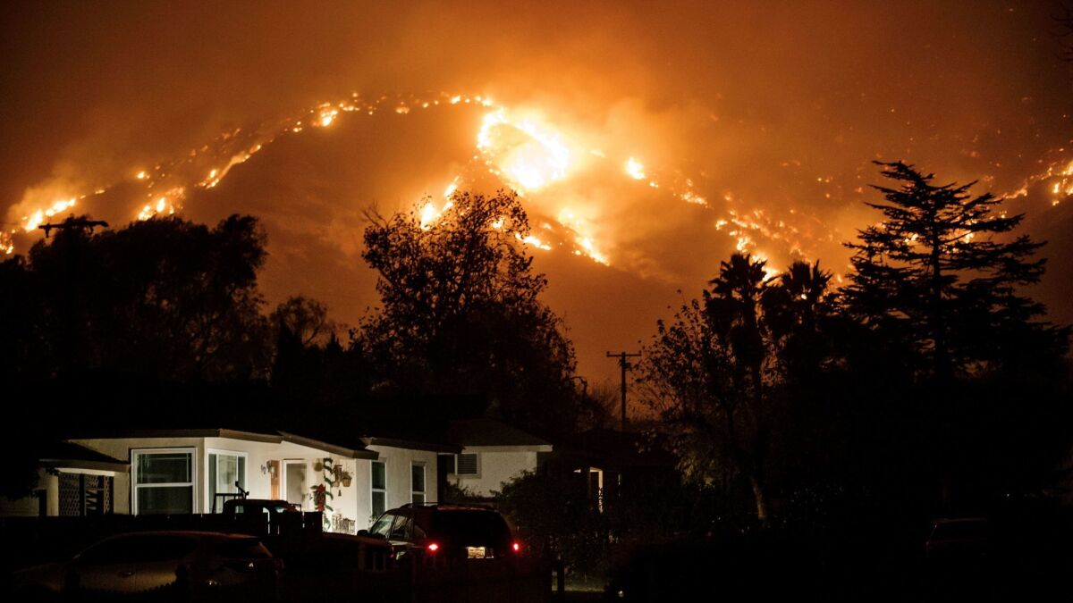 Residents watch the wildfire burn in the mountain ranges north of Ojai, Calif., on Dec. 6.