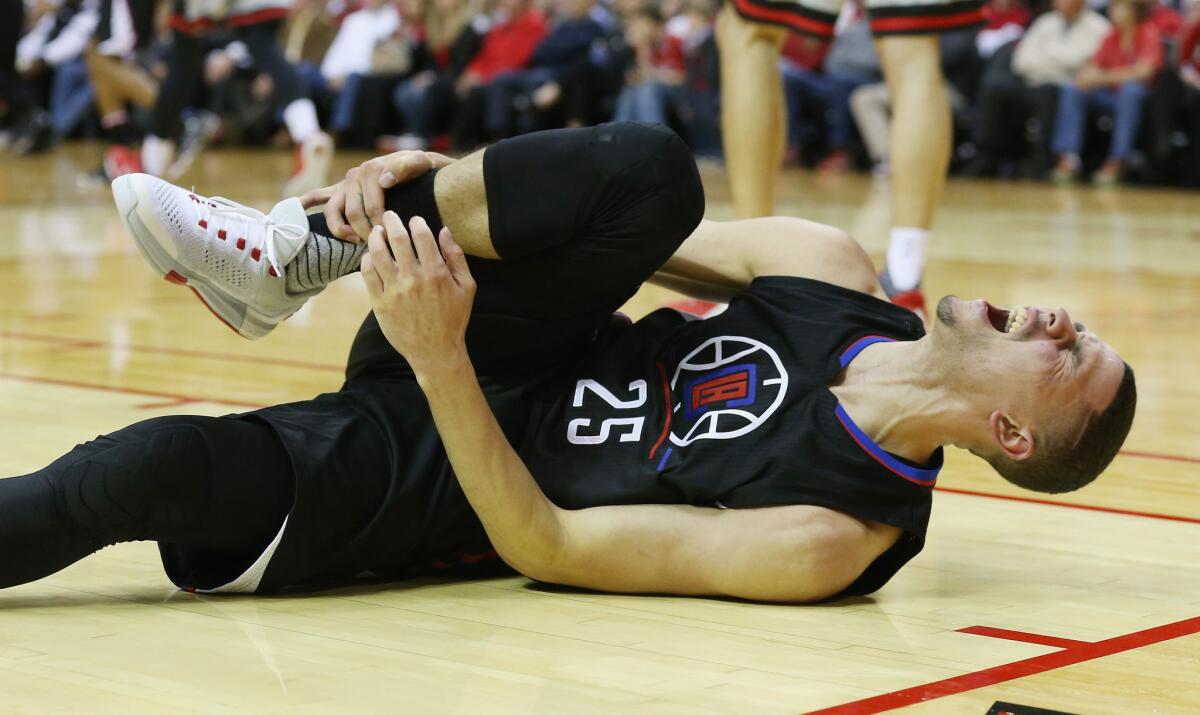 Clippers guard Austin Rivers falls to the court after spraining his ankle during Friday night's game at the Rockets.