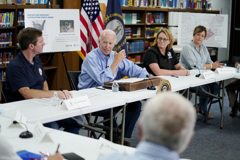 President Joe Biden participates in a briefing at Marie Roberts Elementary School about the ongoing response efforts to devastating flooding, Monday, Aug. 8, 2022, in Lost Creek, Ky. From left are Kentucky Gov. Andy Beshear, Biden, FEMA Administrator Deanne Criswell and Kentucky Lt. Gov. Jacqueline Coleman. (AP Photo/Evan Vucci)