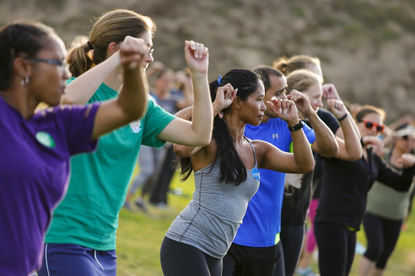 A large crowd, including Kim Tran, center in gray top, filled Redondo Beach's Alta Vista Park for an hour of Zumba.