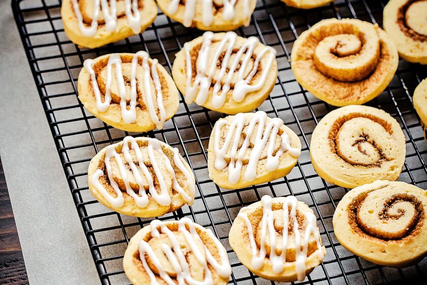 Cinnamon pinwheel bites on a baking rack.