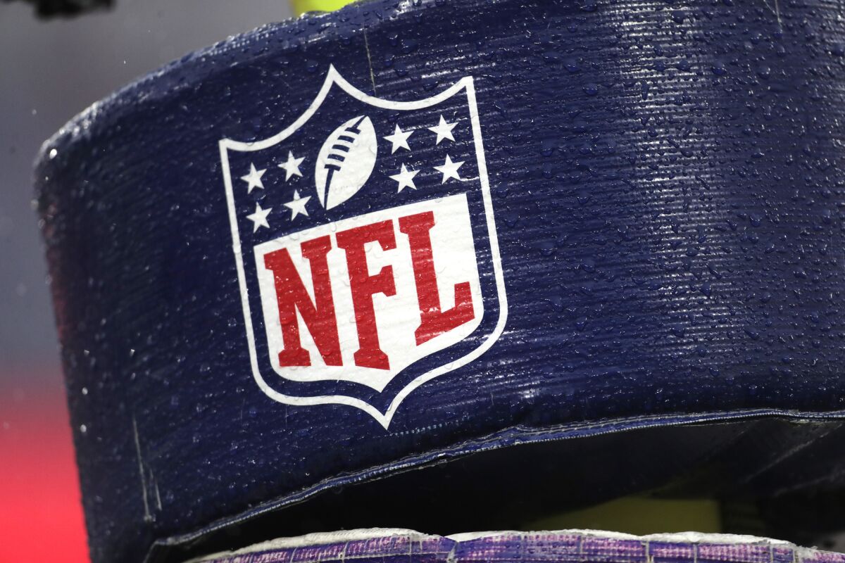 FILE - In this Dec. 1, 2019, file photo, rain drops are seen on the NFL logo on padding of a goal post at an NFL stadium. An NFL and players union-run fund that helps ailing retired players shut down its application process for nearly six months because of the coronavirus. That has irritated retirees who complained the league devoted resources toward safely starting the 2020 season on time but not to their medical needs. (AP Photo/Julio Cortez, File)