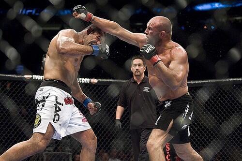 Antonio Nogueira slips a punch thrown by Randy Couture during their heavyweight fight on Saturday night at UFC 102.