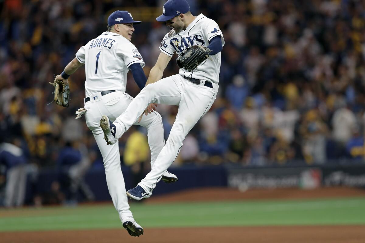 Tampa Bay Rays shortstop Willy Adames (1) and center fielder Kevin Kiermaier celebrate the team's 4-1 win over the Houston Astros in Game 4 of a baseball American League Division Series, Tuesday, Oct. 8, 2019, in St. Petersburg, Fla. (AP Photo/Chris O'Meara)