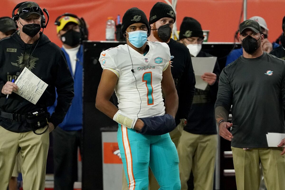 Miami Dolphins quarterback Tua Tagovailoa (1) watches the final minutes from the sidelines during the second half of an NFL football game against the Denver Broncos, Sunday, Nov. 22, 2020, in Denver. (AP Photo/Jack Dempsey)