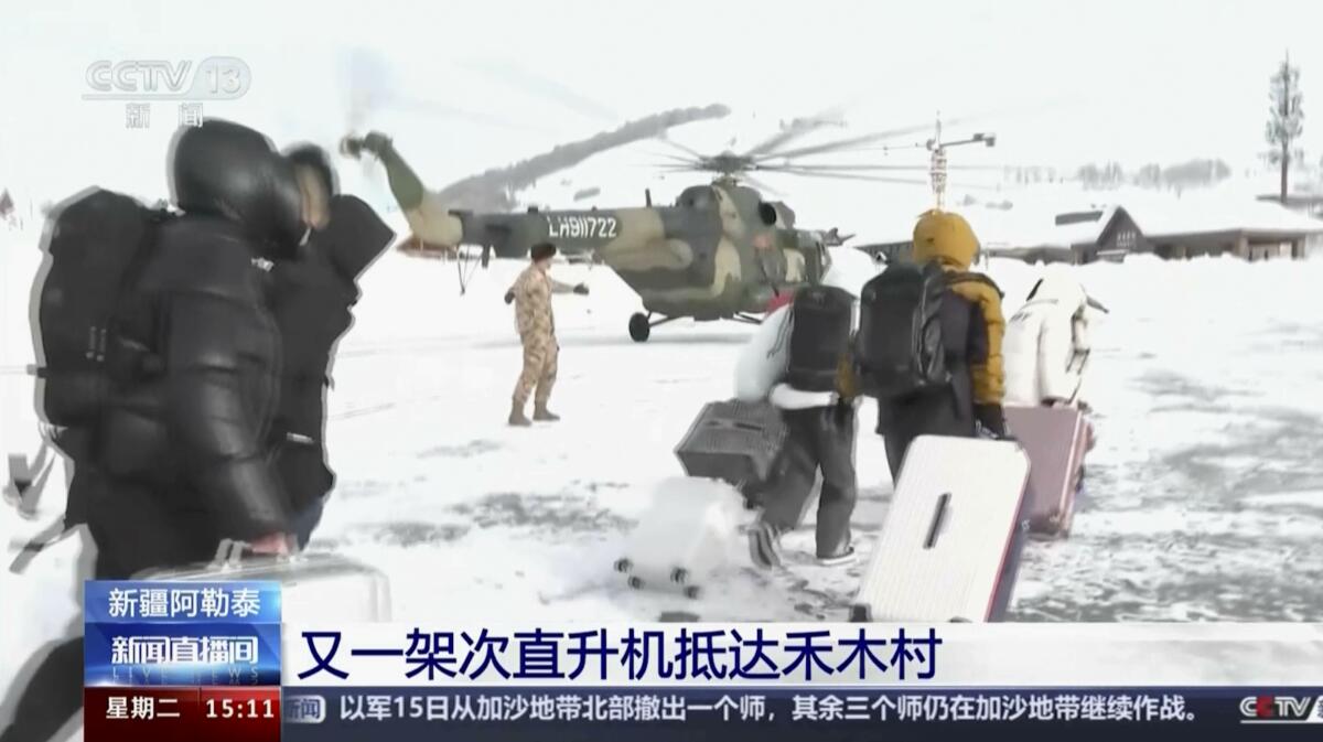 Tourists are evacuated by a military helicopter from Altay Prefecture in northwestern China 