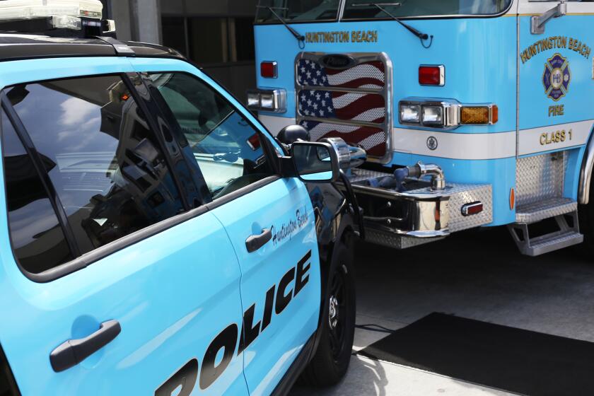 The unveiling of the "wrap" turquoise blue color temporary pseudo-paint job on a Huntington Beach Police vehicle and Huntington Beach fire engine in support of Prostate Cancer Awareness Month at the Huntington Beach Gothard Fire Station 1 in Huntington Beach on Thursday, September 12, 2024. (Photo by James Carbone)