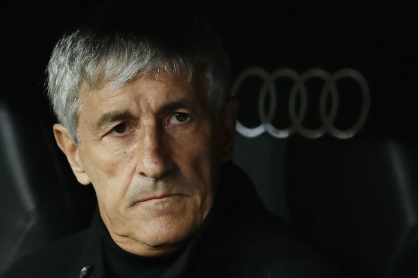 FILE - Barcelona's head coach Quique Setien waits for the start of the Spanish La Liga soccer match between Real Madrid and Barcelona at the Santiago Bernabeu stadium in Madrid, Spain, Sunday, March 1, 2020. Setien believed he had reached the pinnacle of his career three years ago when he was tapped to become the new coach of Barcelona. But his tenure ended after eight months following a humiliating 8-2 defeat to Bayern Munich. On Sunday, Feb. 12, 2023, Setien will face Barcelona for the first time since he was fired following the defeat that has marked his career. (AP Photo/Manu Fernandez, File)