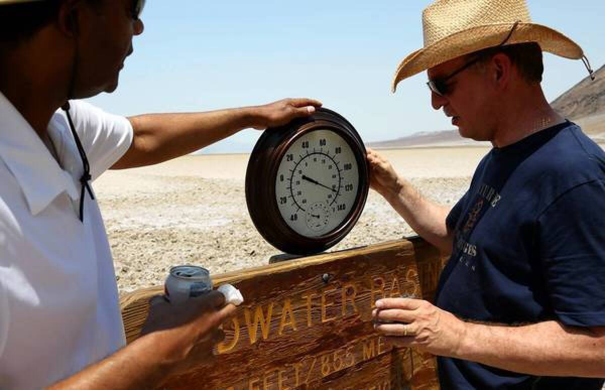 Randy Thomas of Vacaville, left, with Andreas Kinnen of Germany, brought his own thermometer to Badwater Basin in Death Valley.