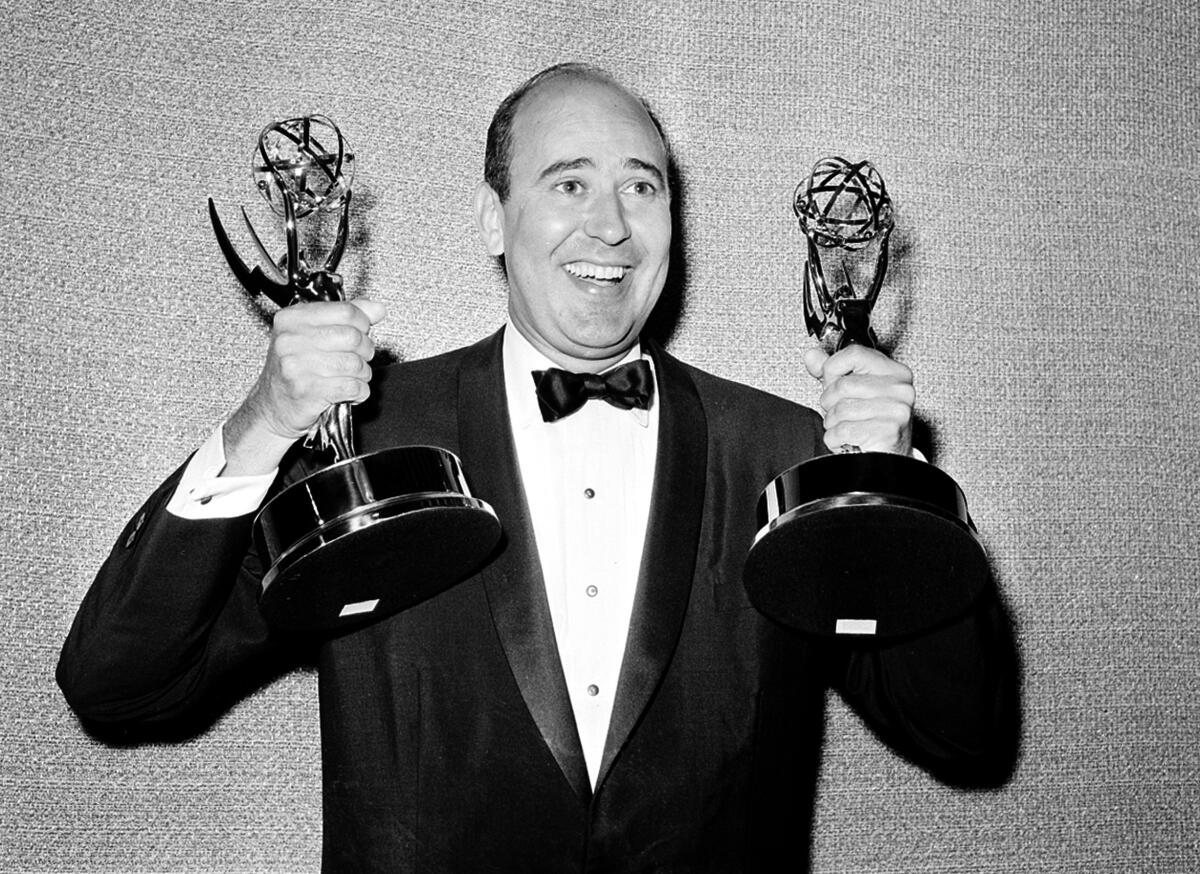 Carl Reiner holds two Emmy statuettes presented to him as best comedy writer for "The Dick Van Dyke Show" in 1963.