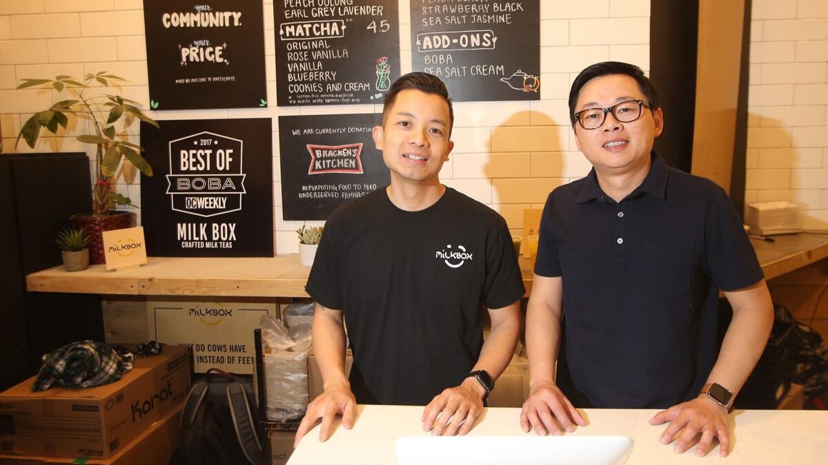 Milk Box owners and founders Truong Kim, left, and Robert Huong hand-craft milk teas in the District at Tustin Legacy and at their Mission Viejo store. Customers pay what they can, sometimes going over suggested price, with half going to charity.