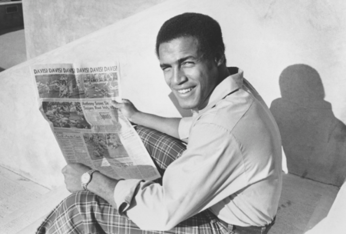 USC running back Anthony Davis holds a newspaper telling of his six touchdowns against Notre Dame on Dec. 6, 1972. 