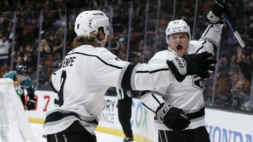 Kings right wing Carl Grundstrom, right, celebrates his first-period goal with center Adrian Kempe during a game against the Ducks on March 10.