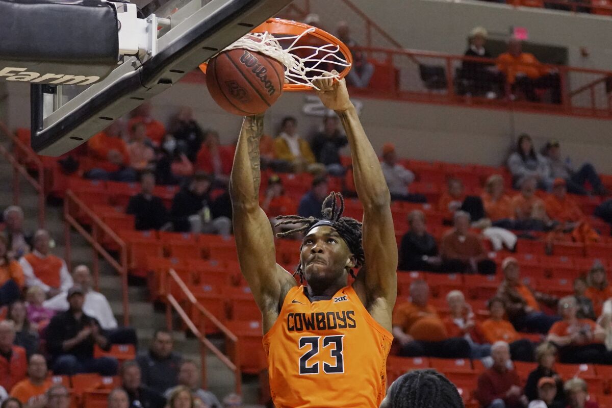 Oklahoma State forward Tyreek Smith (23) dunks in the first half of an NCAA college basketball game against Cleveland State, Monday, Dec. 13, 2021, in Stillwater, Okla. (AP Photo/Sue Ogrocki)