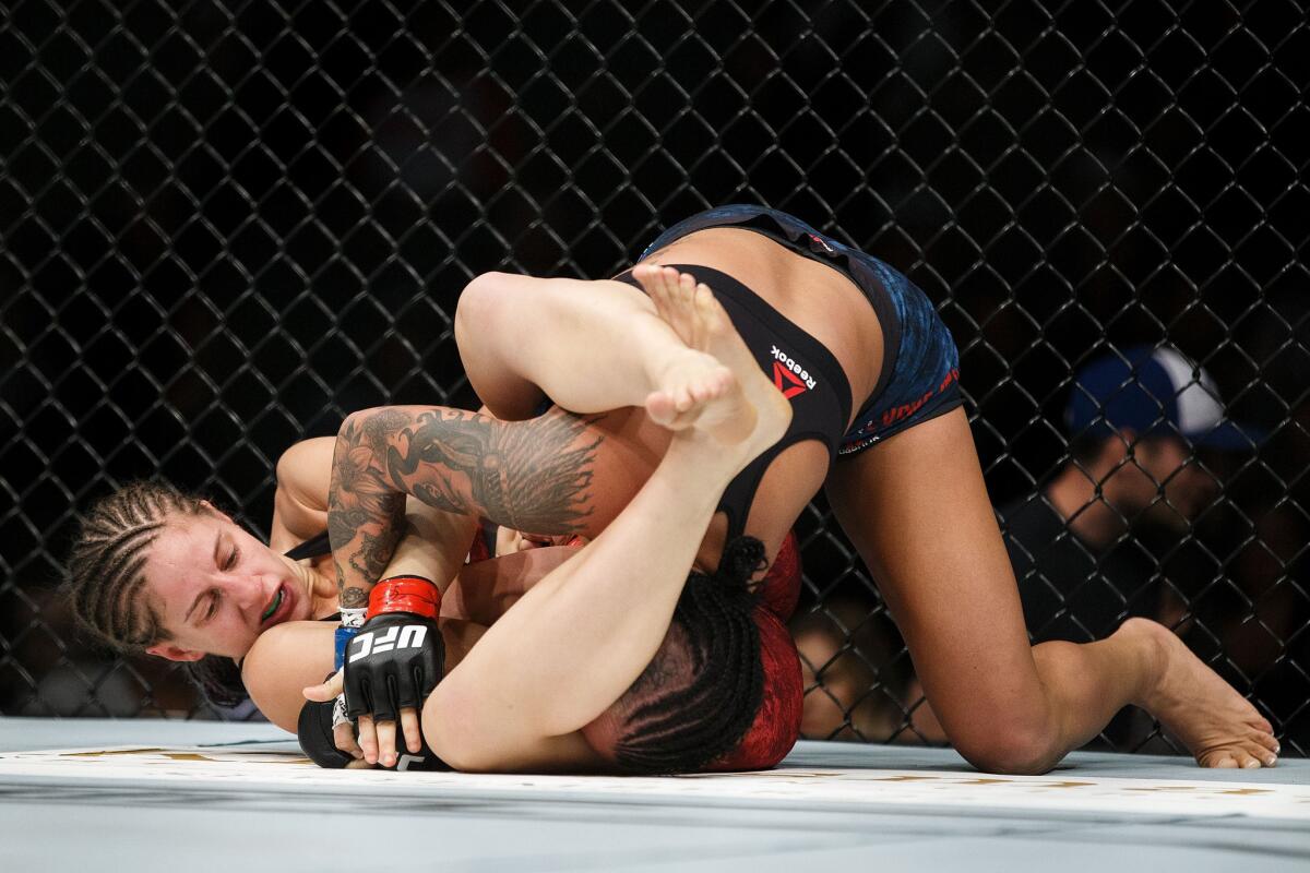 Sarah Moras goes for the submission against Ashley Evans-Smith during their bout at UFC 215.