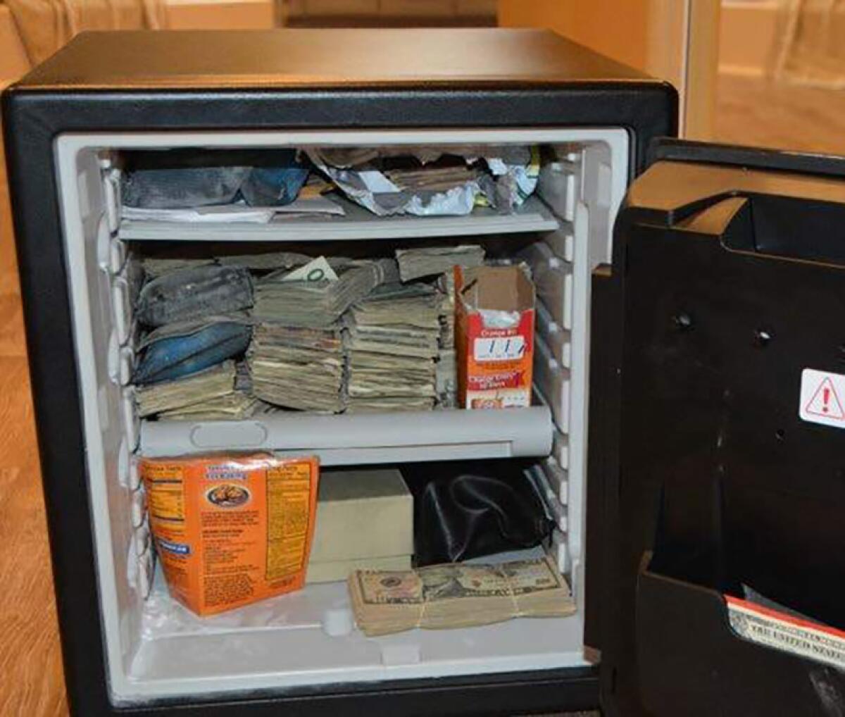 Bundles of cash stacked in a mini-refrigerator .