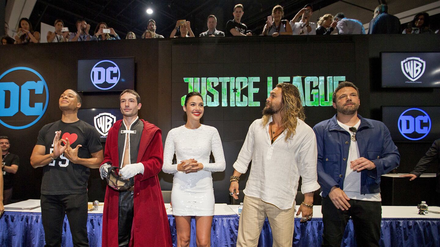 The cast of "Justice League," from left, Ray Fisher as Cyborg, Ezra Miller as Flash, Gal Gadot as Wonder Woman, Jason Momoa as Aquaman and Ben Affleck as Batman, arrives Saturday at the DC Comics booth at Comic-Con 2017.