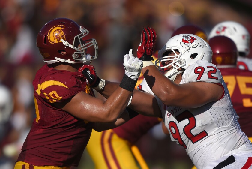 USC's Toa Lobendahn battles Fresno State defensive lineman Tyeler Davison during a game on Aug. 30, 2014.